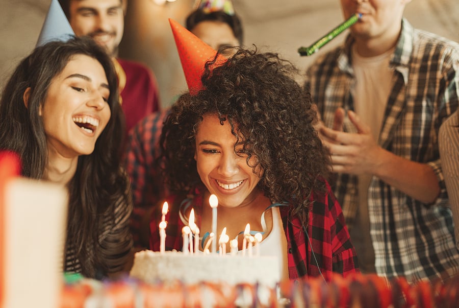 Excited Girl Ready To Blow Out Candles On Cake On Birthday Party